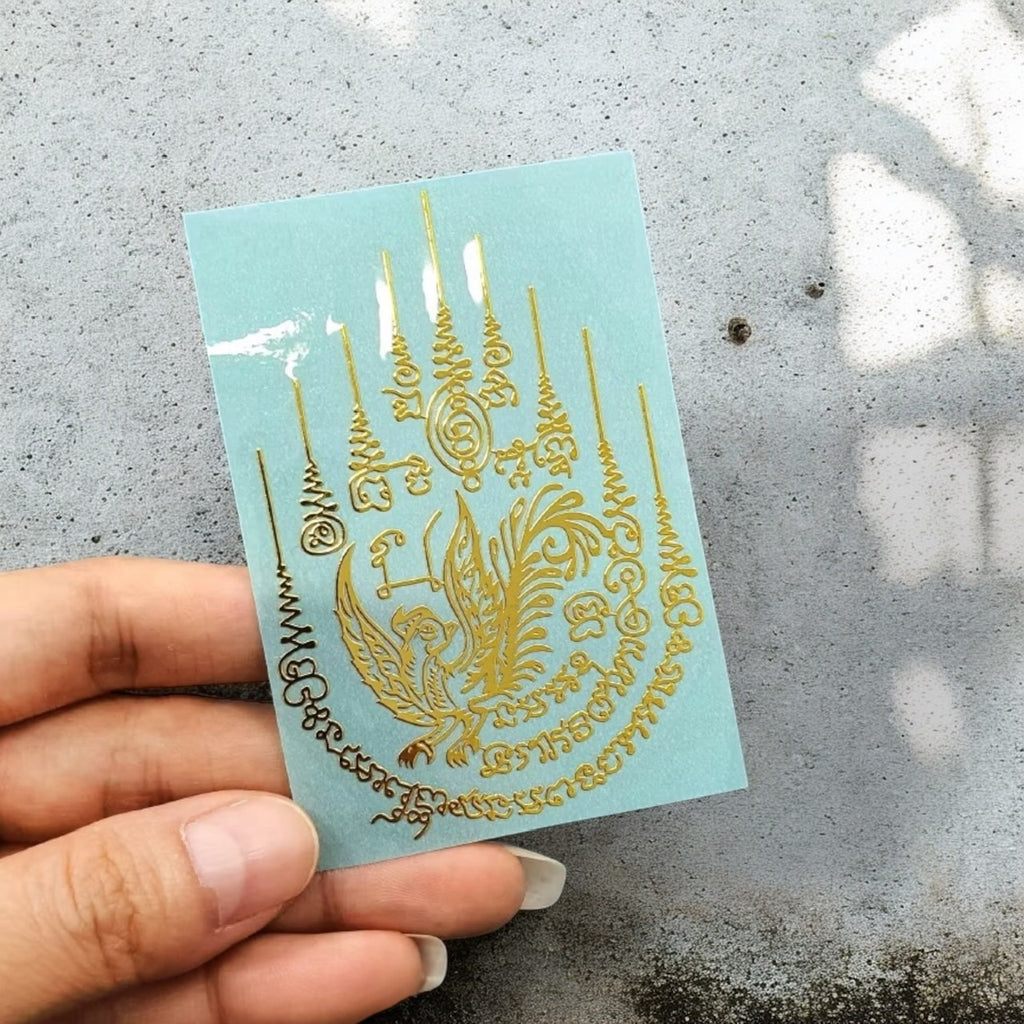 Yant Salika Maha Sanaeh charm bird gold embossed Thai amulet sticker close-up